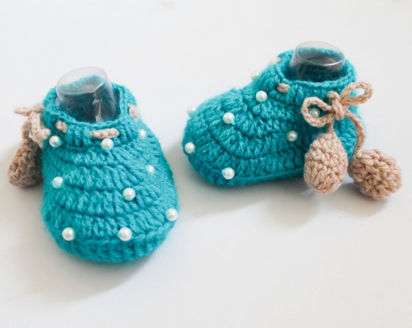 A pair of pearl detailed booties