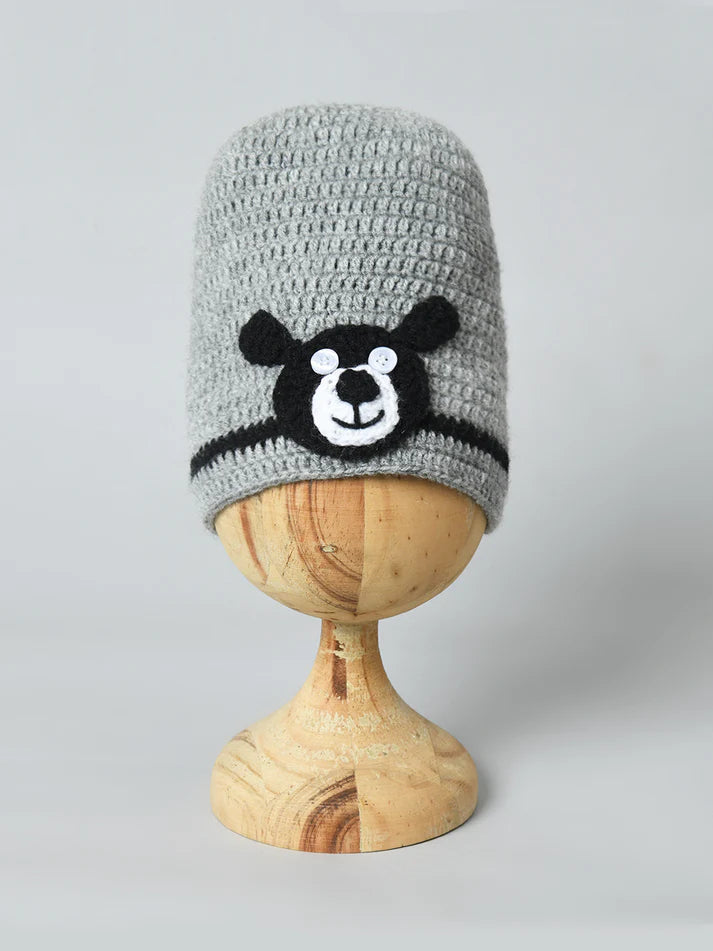 Bold Bear Design: A playful black bear applique with a happy face brings a fun and friendly vibe to winter outfits