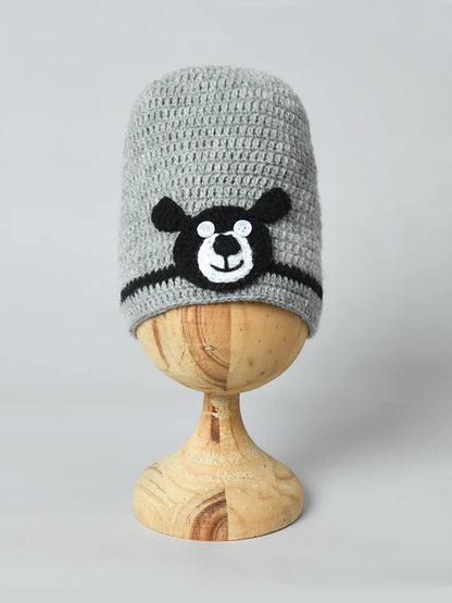 Bold Bear Design: A playful black bear applique with a happy face brings a fun and friendly vibe to winter outfits